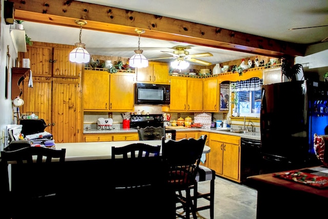 kitchen with pendant lighting, sink, ceiling fan, black appliances, and beamed ceiling