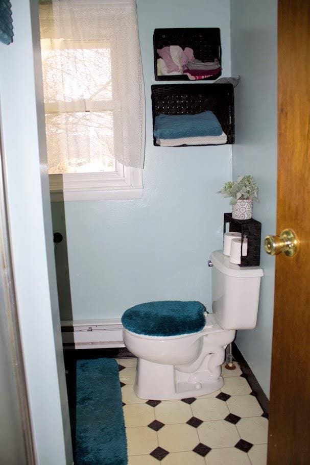 bathroom with a baseboard radiator and toilet