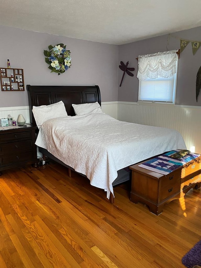 bedroom featuring hardwood / wood-style floors and a textured ceiling