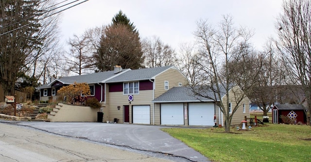 view of front of property featuring a garage and a front yard