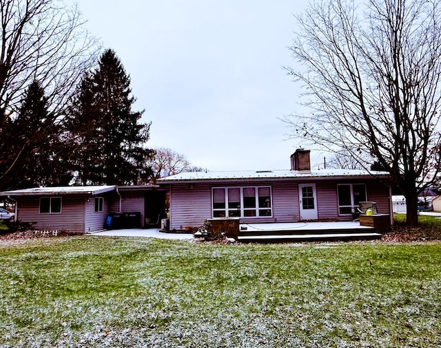 rear view of property with a deck and a yard