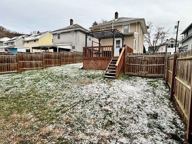 back of house with a deck, a fenced backyard, and a pergola