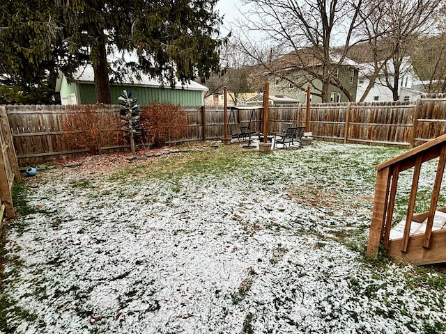 yard covered in snow featuring a fire pit and a fenced backyard