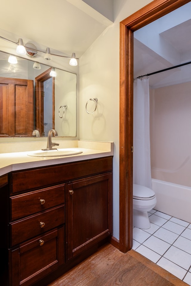 full bathroom featuring tile patterned flooring, shower / tub combo, vanity, and toilet