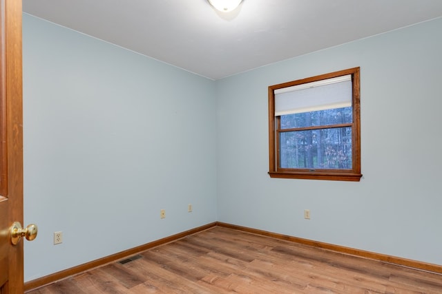 spare room with wood-type flooring