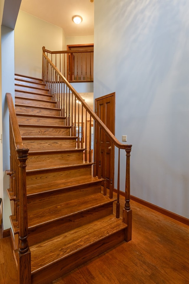 stairs featuring hardwood / wood-style flooring