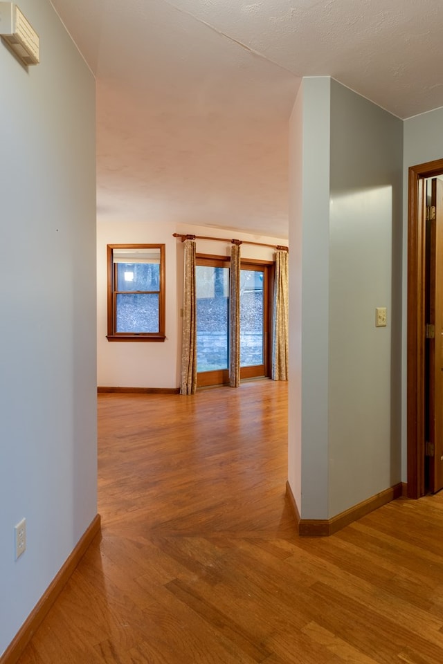 hallway with light hardwood / wood-style floors