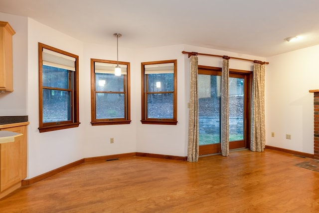 unfurnished dining area featuring light hardwood / wood-style floors