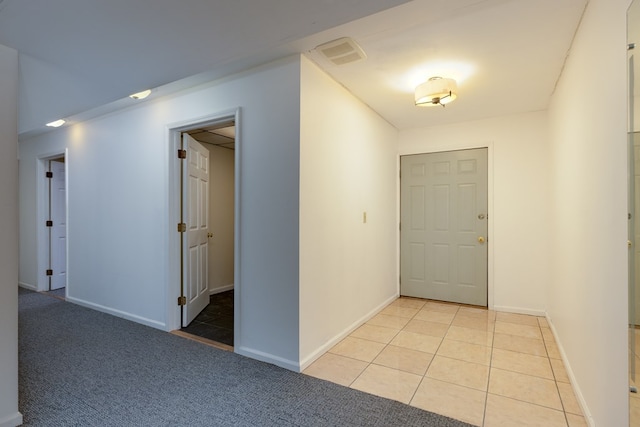 foyer entrance with light tile patterned floors