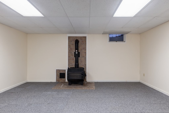 basement with a drop ceiling and carpet