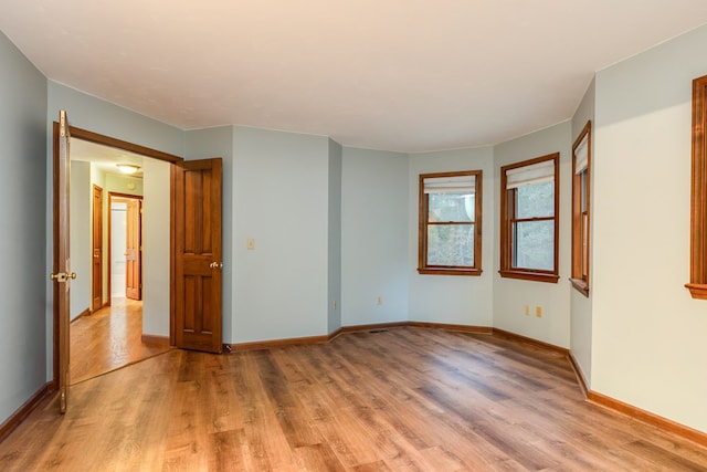 spare room with light hardwood / wood-style floors