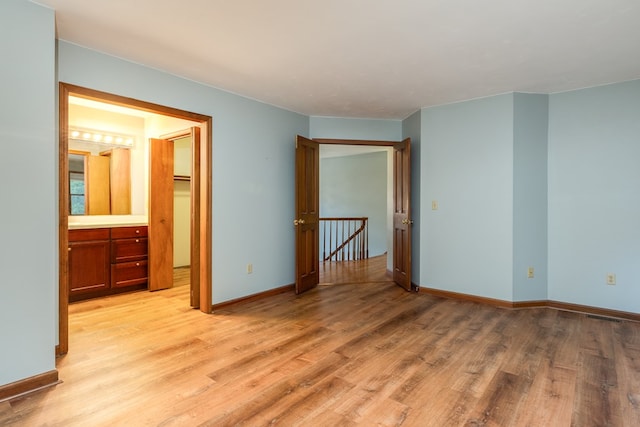 empty room with light hardwood / wood-style flooring