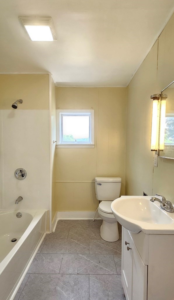 full bathroom featuring tile patterned flooring, vanity, shower / bathtub combination, and toilet