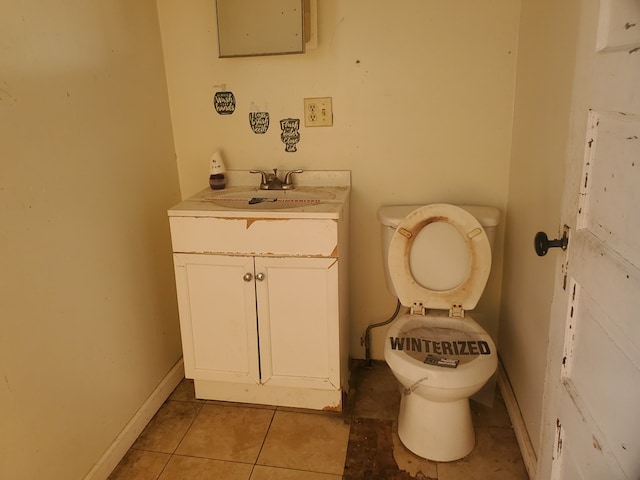 bathroom featuring tile patterned flooring, vanity, and toilet