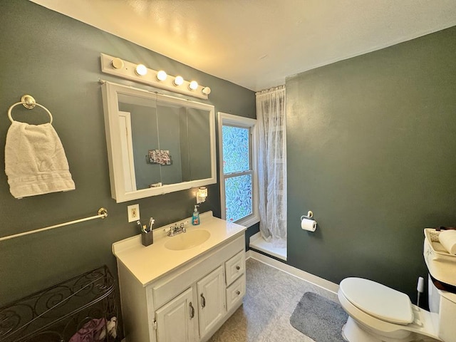 bathroom featuring toilet and vanity