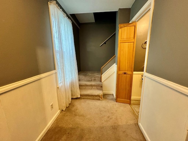 hall featuring light colored carpet