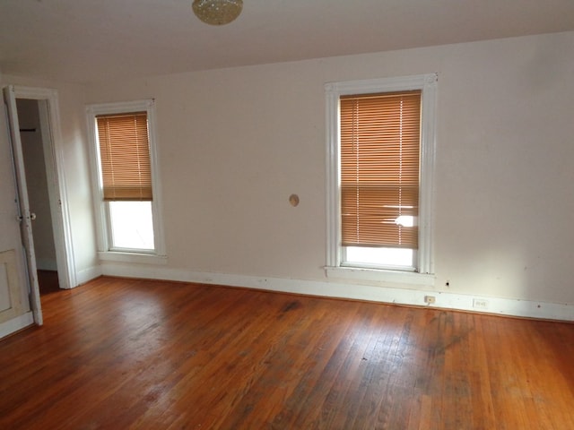 spare room with dark wood-type flooring