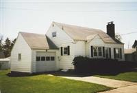 view of front of house with a garage and a front lawn