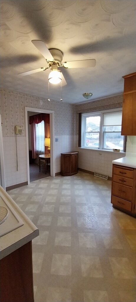 unfurnished dining area featuring ceiling fan