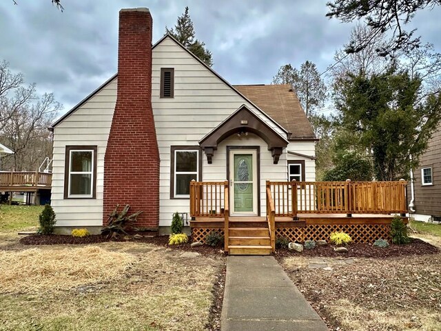 back of house with a wooden deck