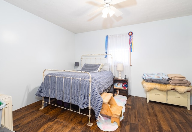 bedroom with dark wood-type flooring and ceiling fan