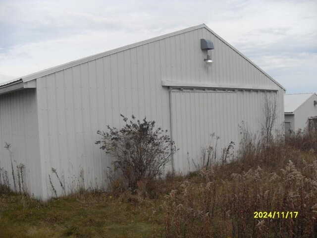 view of side of property featuring an outbuilding