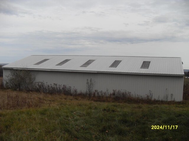 view of side of property with an outbuilding