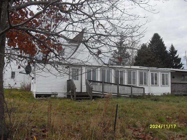 rear view of property with a wooden deck