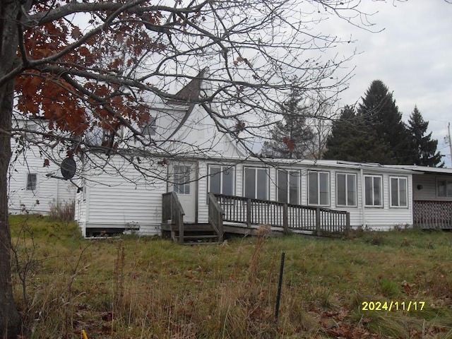 rear view of house with a wooden deck