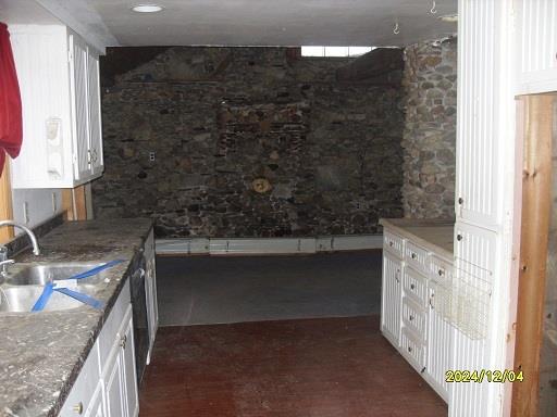 kitchen featuring white cabinets, dark hardwood / wood-style floors, and sink