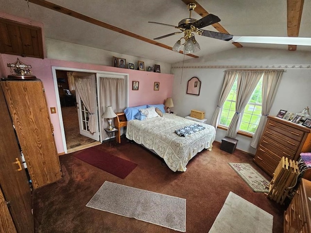 bedroom featuring vaulted ceiling with skylight, ceiling fan, and dark carpet