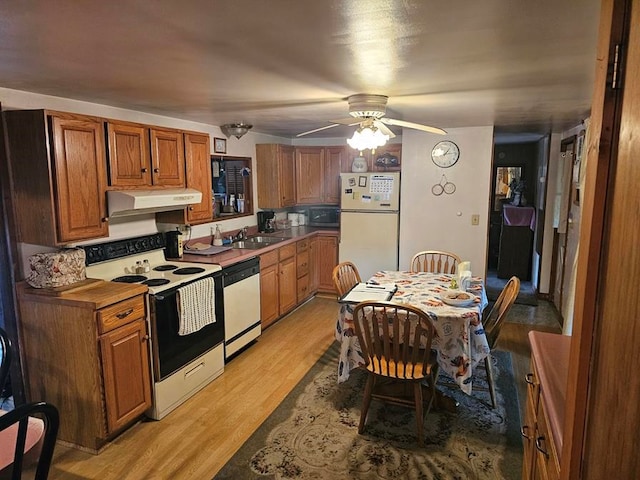 kitchen featuring light wood-type flooring, white appliances, ceiling fan, and sink