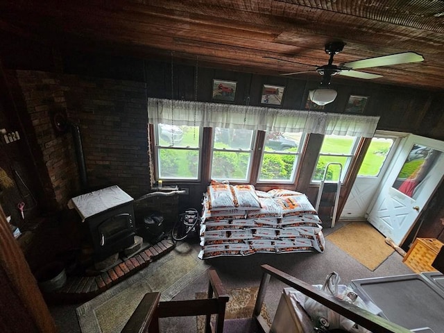 bedroom featuring ceiling fan, wood ceiling, and wood walls