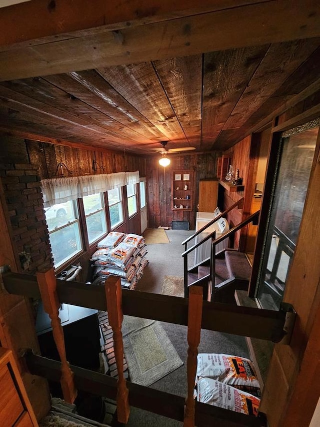 bedroom featuring wooden ceiling and wooden walls