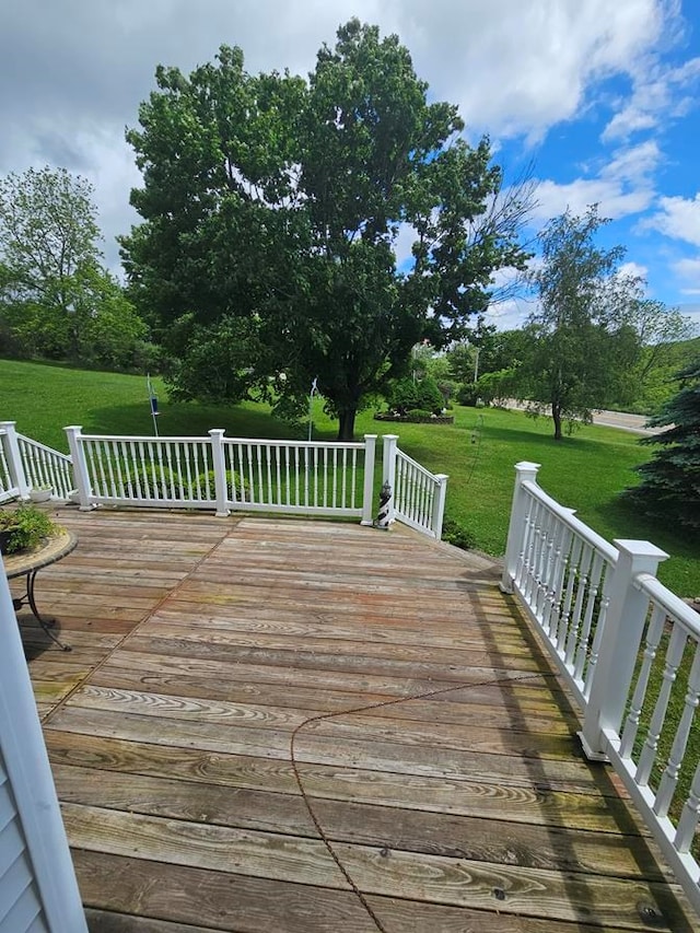 wooden terrace with a lawn