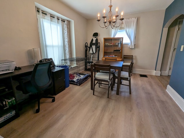 office area featuring a chandelier and light hardwood / wood-style floors