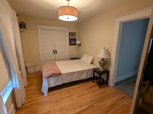 bedroom featuring light wood-type flooring and a closet