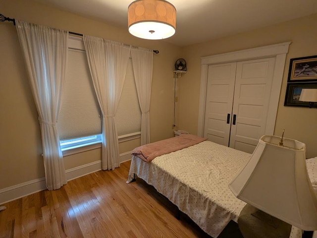 bedroom with a closet and light hardwood / wood-style floors