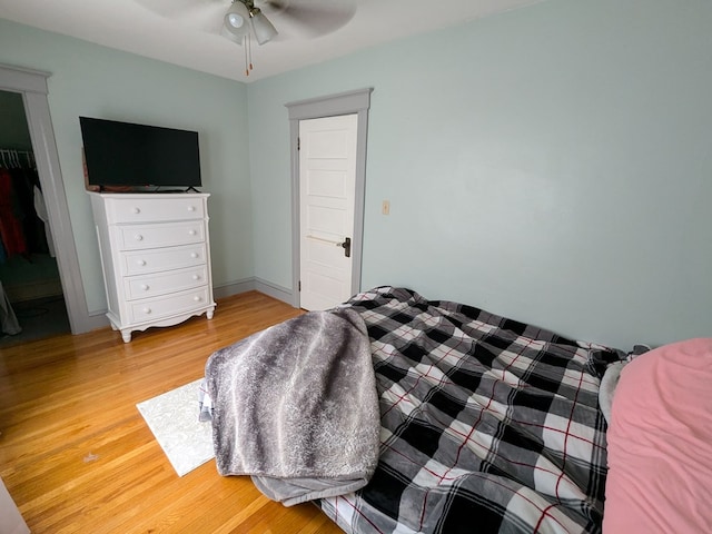 bedroom featuring wood-type flooring, a closet, and ceiling fan