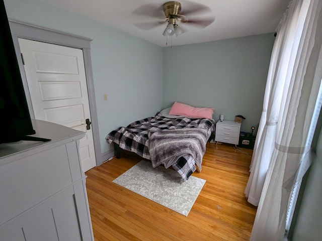 bedroom with ceiling fan and light hardwood / wood-style floors