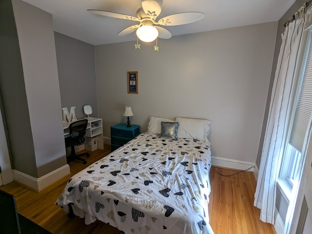 bedroom with ceiling fan and light hardwood / wood-style floors