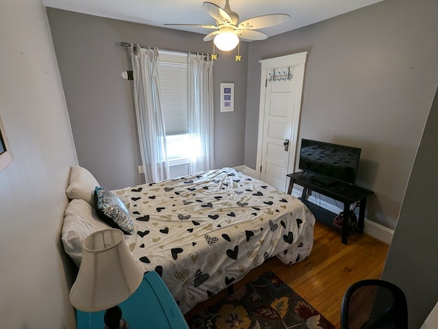 bedroom with ceiling fan and wood-type flooring