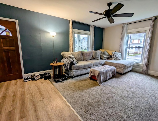 living room featuring wood-type flooring, plenty of natural light, and ceiling fan