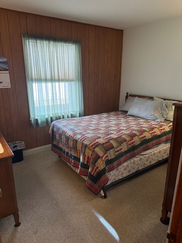 carpeted bedroom with wooden walls