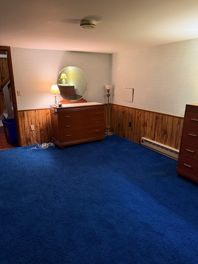 unfurnished room with dark colored carpet and a baseboard heating unit