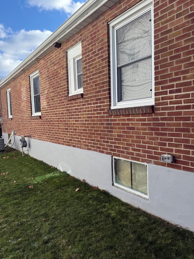 view of side of home with a yard