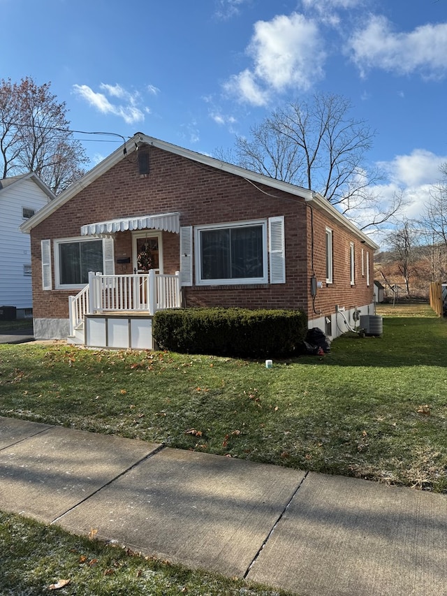 view of front of house featuring a front yard and cooling unit