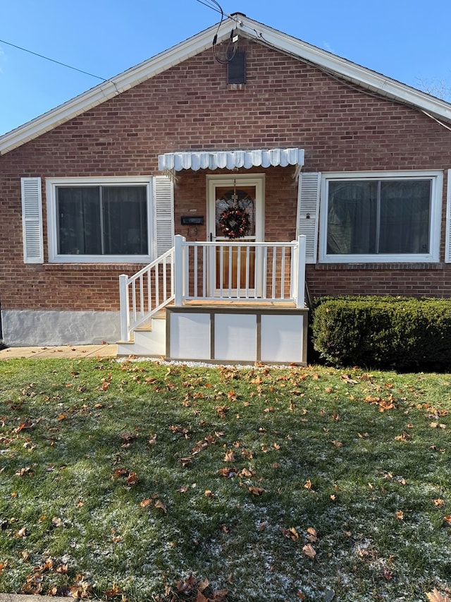 back of house with a lawn