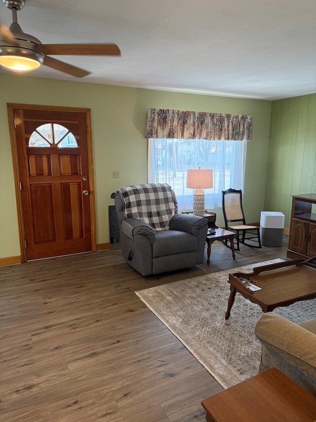 living room featuring ceiling fan and wood-type flooring