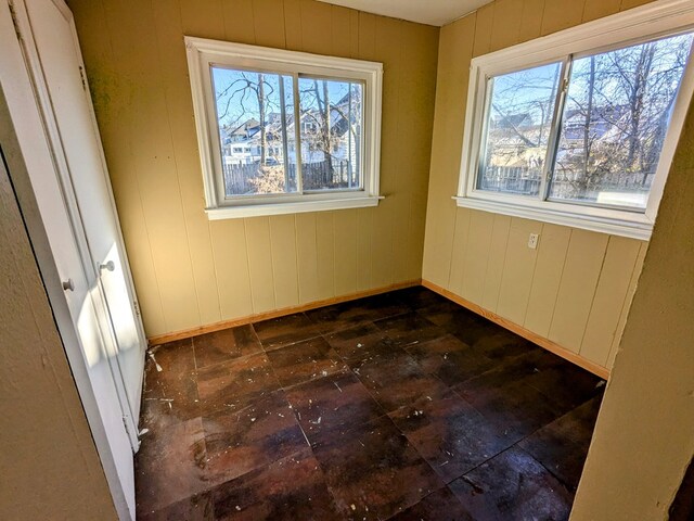 empty room featuring wood walls